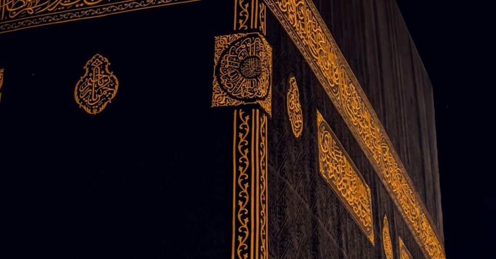 Close-up of the Kaaba in Mecca, Saudi Arabia, showing intricate golden patterns at night.